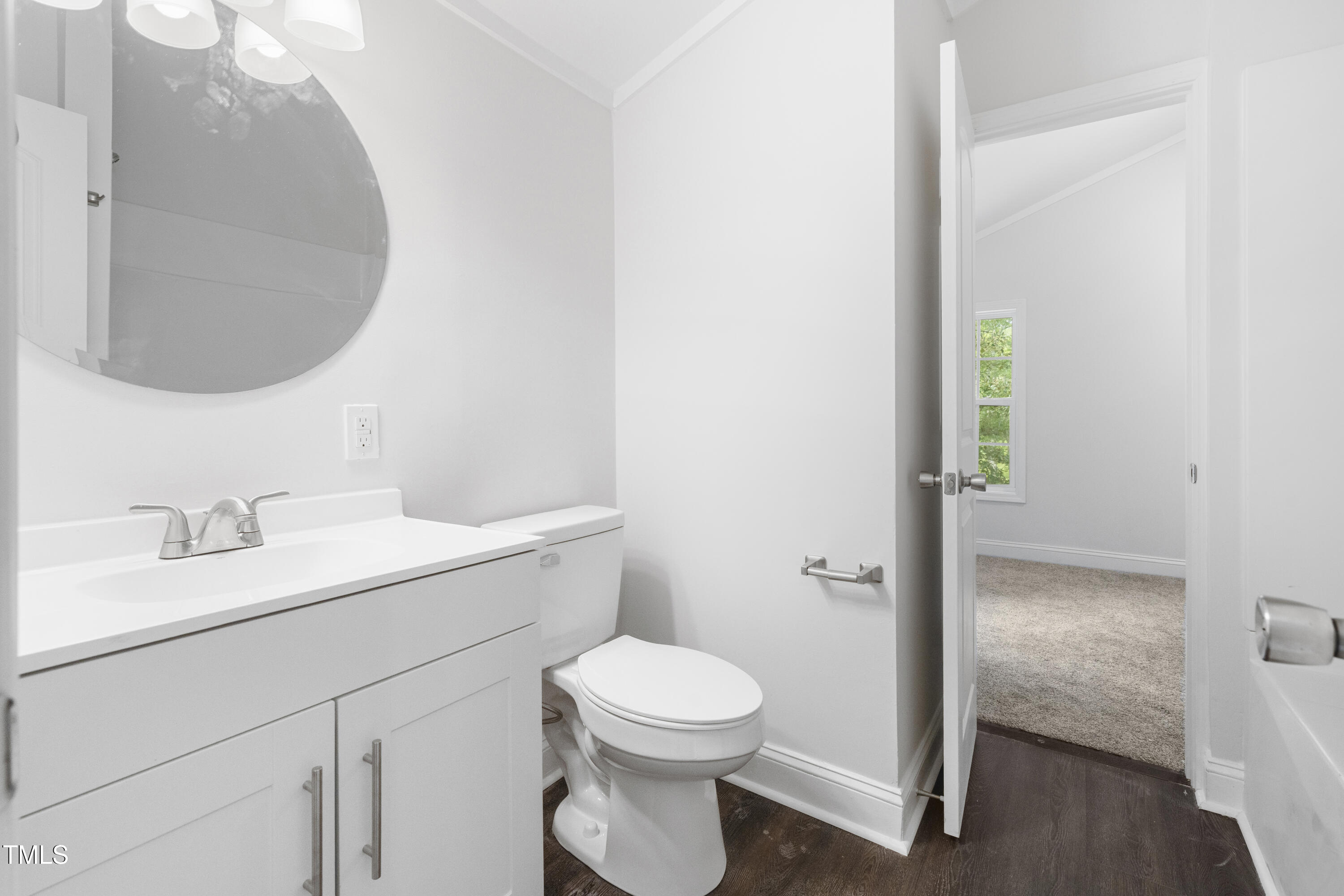 951 Walter Bright Road Sanford, NC 27330 - Photo 23 of 42 a bathroom with a toilet a sink and mirror