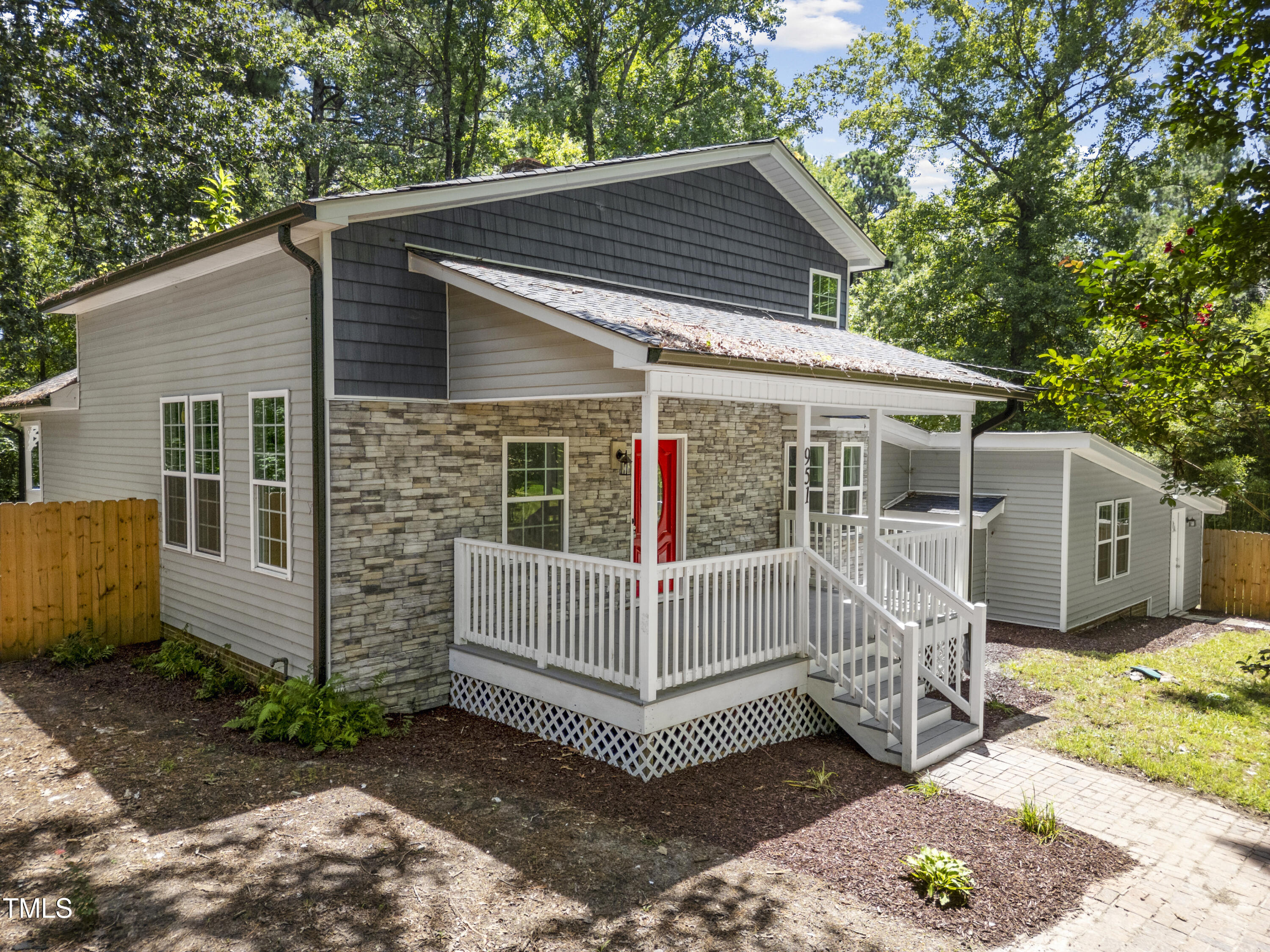 951 Walter Bright Road Sanford, NC 27330 - Photo 29 of 42 a view of a small house with a small deck and a large tree