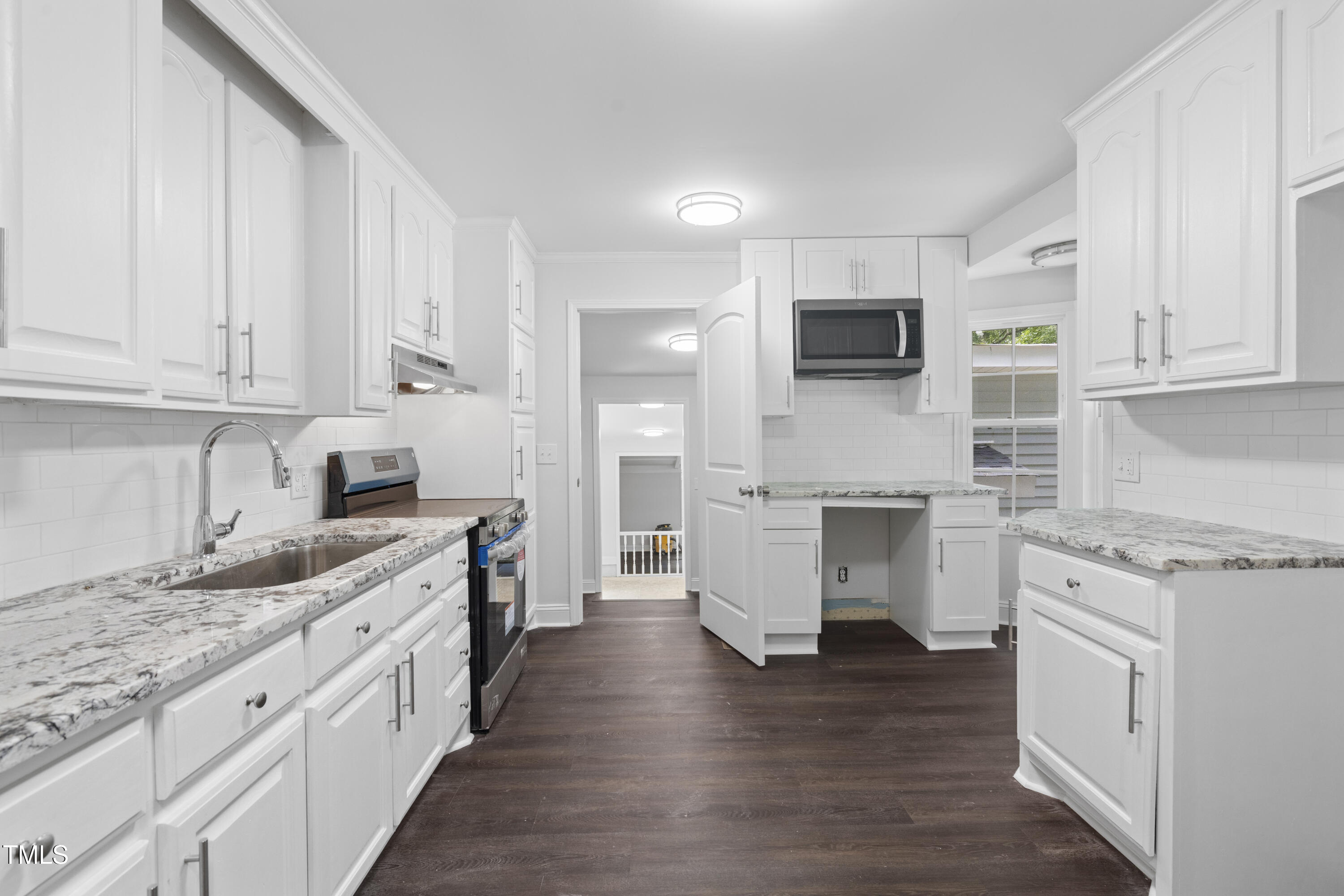 951 Walter Bright Road Sanford, NC 27330 - Photo 9 of 42 a kitchen with stainless steel appliances granite countertop a stove top oven a sink dishwasher and a microwave oven with white cabinets