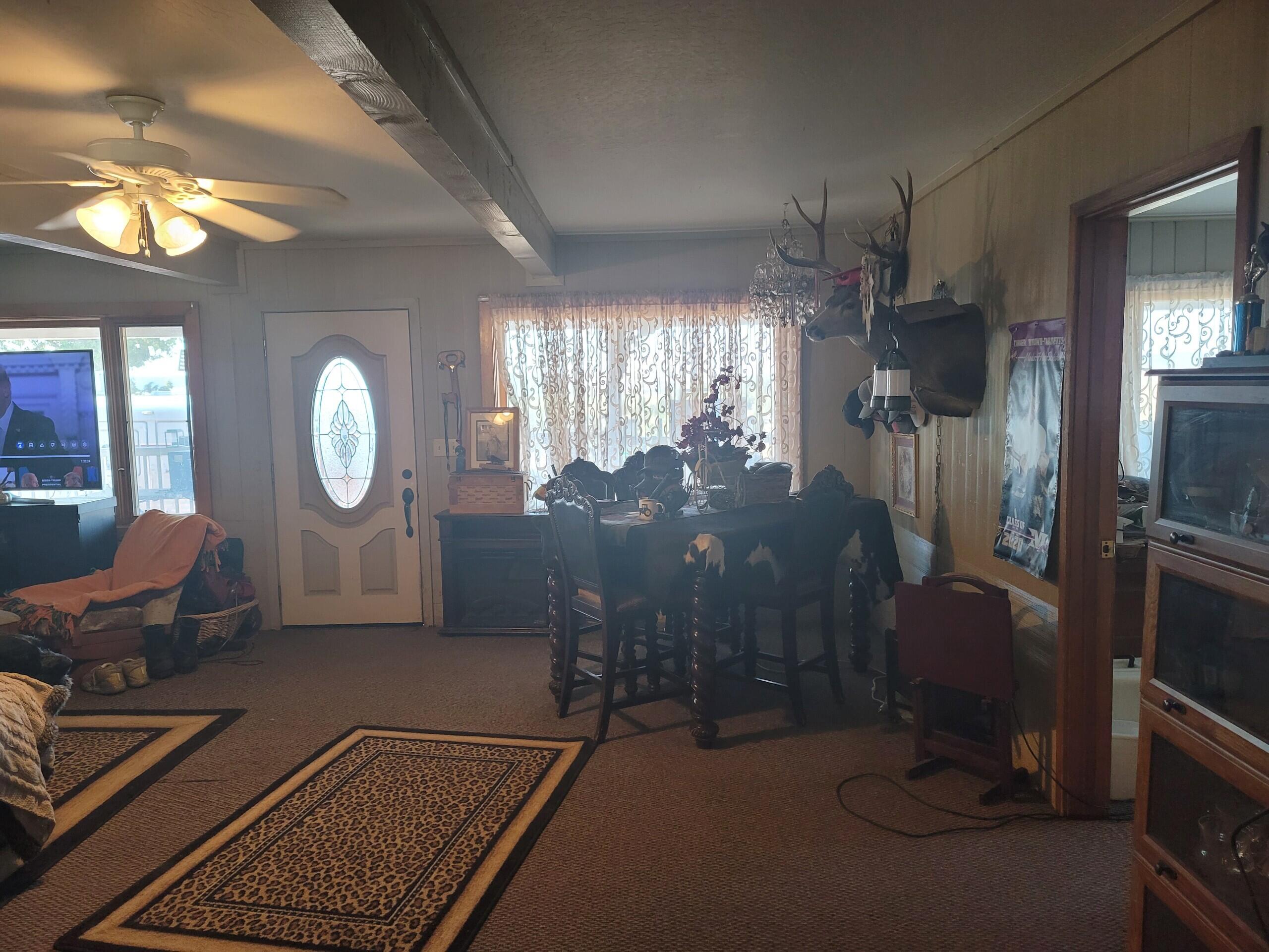 3900 Centerville Road Canby, CA 96015 - Photo 8 of 9 a living room with furniture a chandelier and a mirror