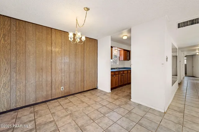 a kitchen view with stainless steel appliances granite countertop a refrigerator and a stove top oven