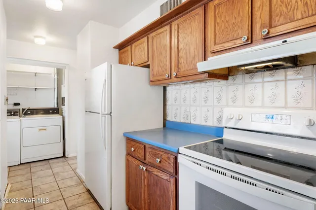 a kitchen with a stove cabinets and a refrigerator