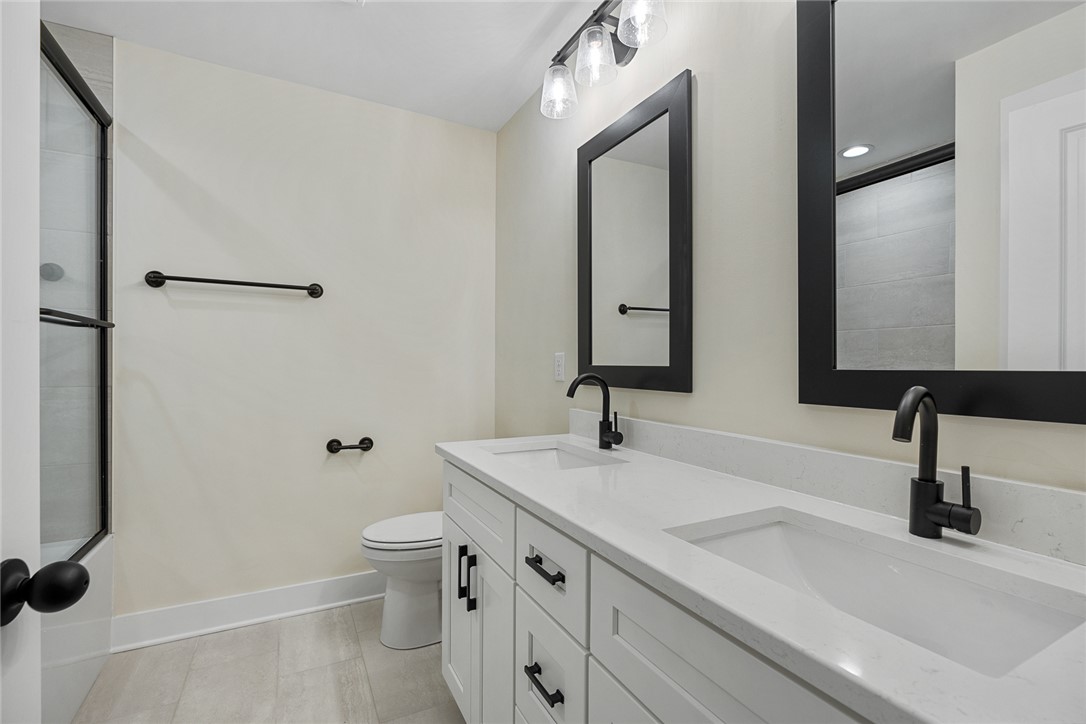 100 Garden Gate Drive Anderson, SC 29621 - Photo 28 of 43 This modern bathroom features a dual vanity and a spacious walk-in shower.