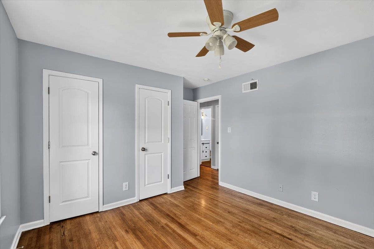 1744 West Holmes Road Memphis, TN 38109 - Photo 15 of 24 Wood-finish flooring with light gray wall paint and white trim