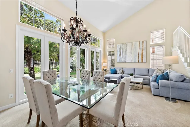 a dining room with furniture a chandelier and a rug