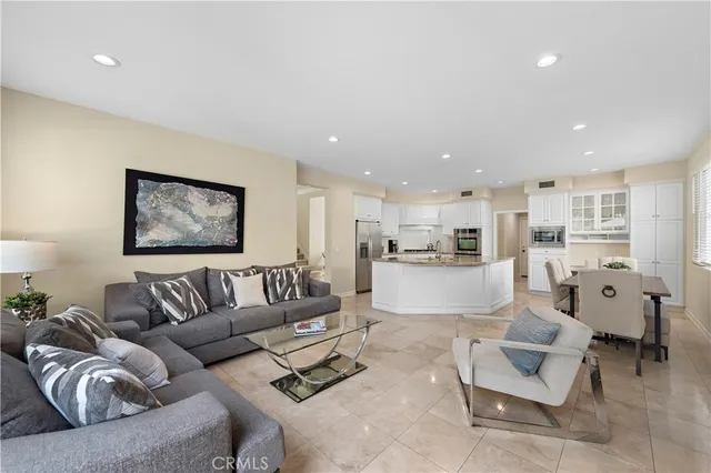 a living room with furniture kitchen and a couch