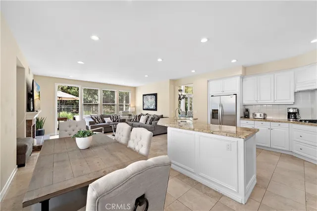 a very nice looking open dining room with kitchen island furniture and a large window