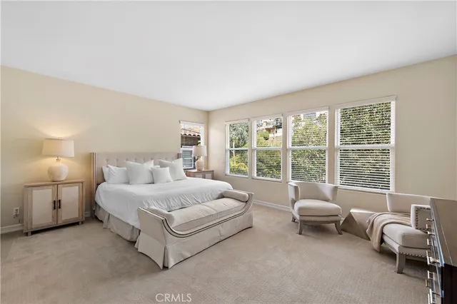 a spacious bedroom with a bed and a large window