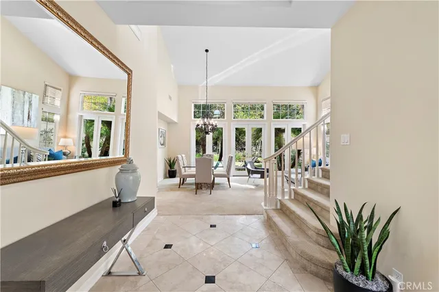 a living room with furniture and large windows