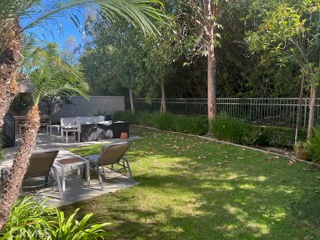 a view of a sitting area with furniture in backyard