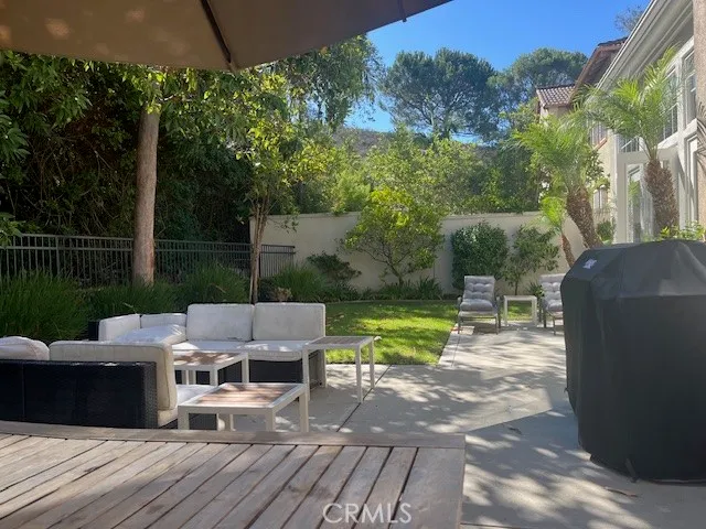 a view of backyard with seating space and trees