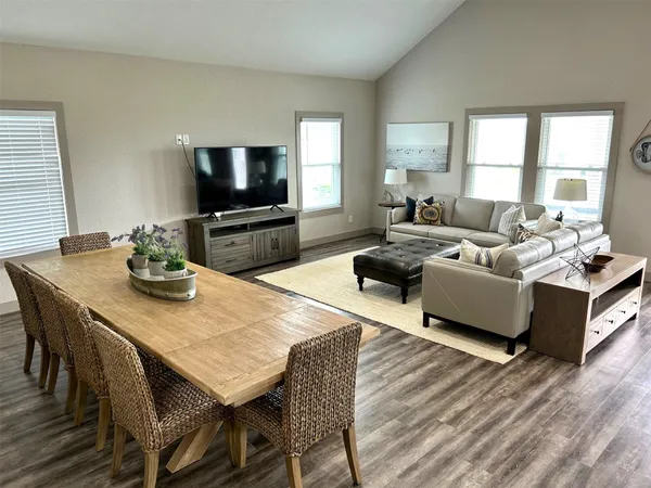 a living room with furniture a flat screen tv and a large window