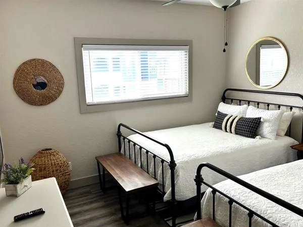 a bedroom with a bed window and a table