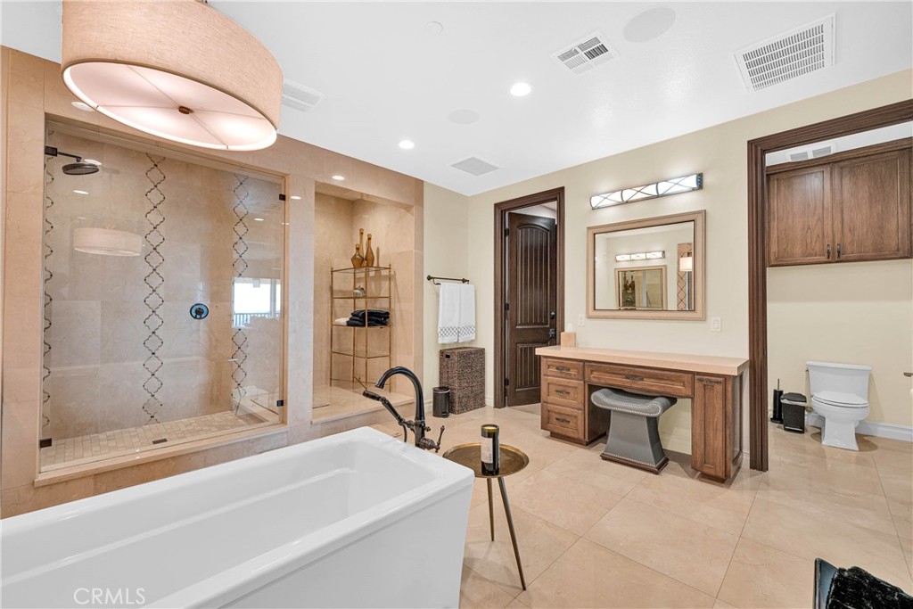 16727 Pienza Court Riverside, CA 92503 - Photo 29 of 41 Freestanding soaking tub in a marble-finished room