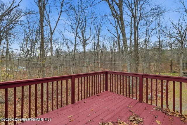 a view of balcony with wooden floor and fence
