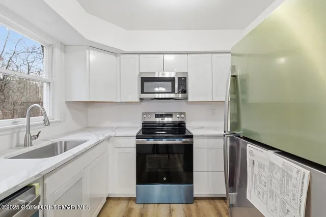 a kitchen with granite countertop a stove and a sink