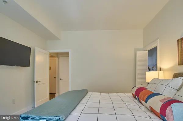 a bedroom with a bed and a couch