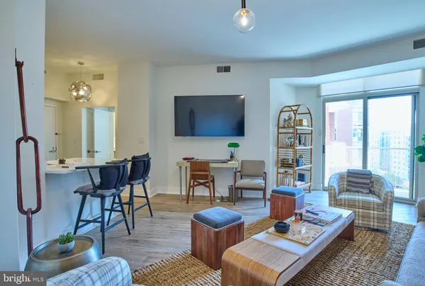 a living room with furniture a rug and a large window