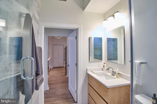 a bathroom with a double vanity sink mirror and toilet