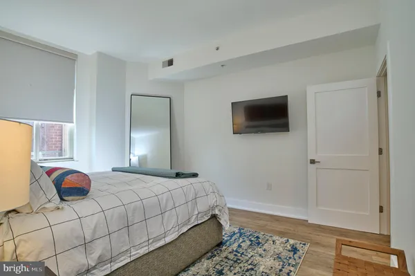 a bedroom with a bed and a flat screen tv