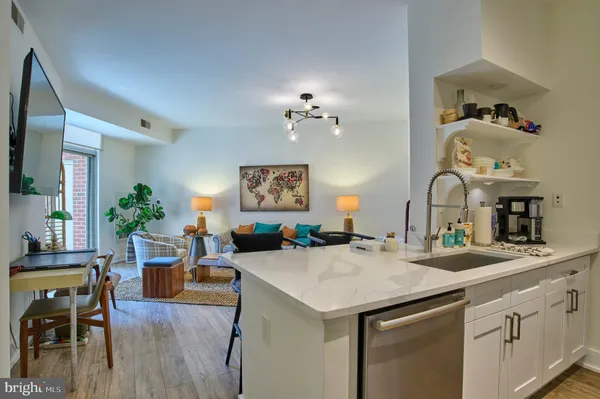 a view of a kitchen area with furniture and wooden floor