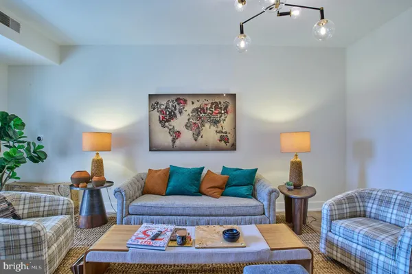 a living room with furniture and a lamp