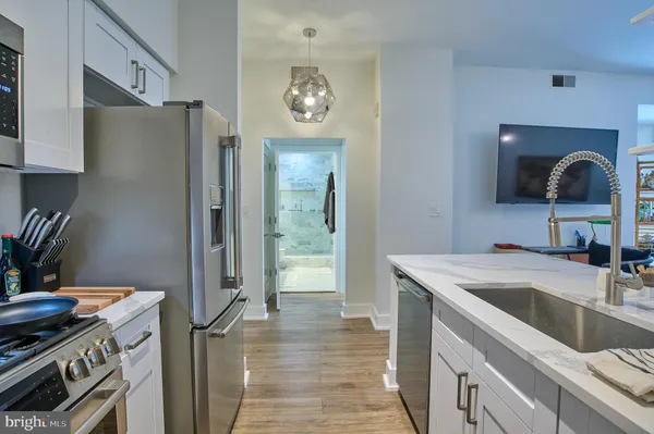 a kitchen with stainless steel appliances granite countertop a refrigerator and a sink
