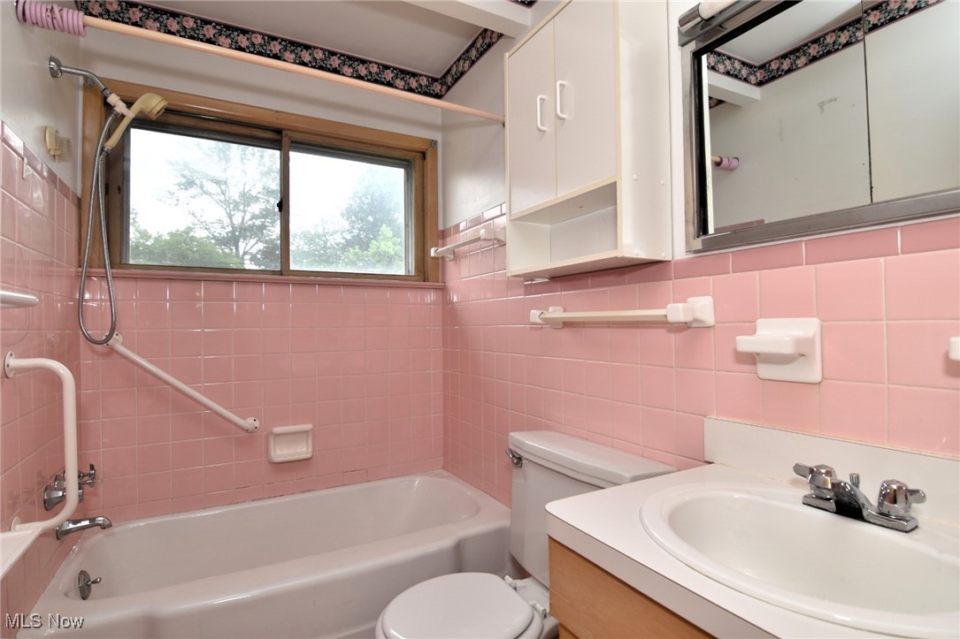 9421 David Road Cleveland, OH 44125 - Photo 26 of 36 Full bathroom with tub / shower combination, vanity, and tile walls