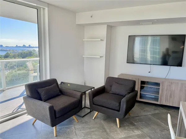 a living room with furniture and a flat screen tv