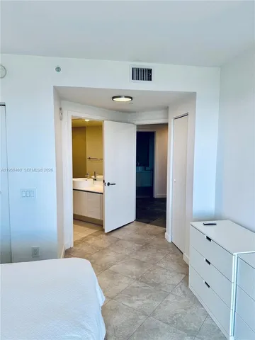 a en suite bathroom with a sink and a mirror