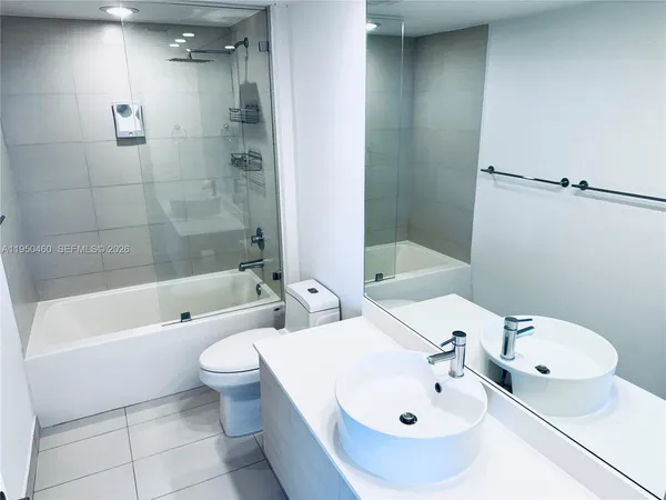 a bathroom with a toilet a sink and bathtub