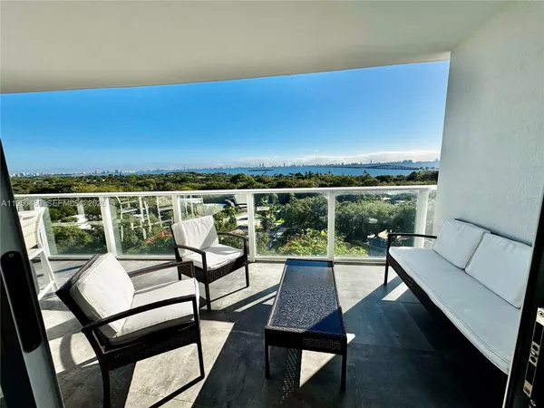 a view of a chairs and table in the balcony