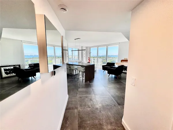 a living room with furniture and a large window