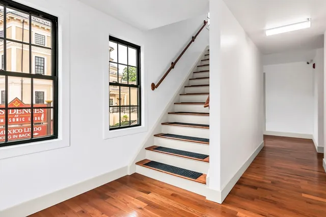 a view of a room with wooden floor and windows