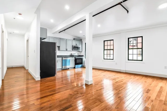 a view of a kitchen with wooden floor and a kitchen