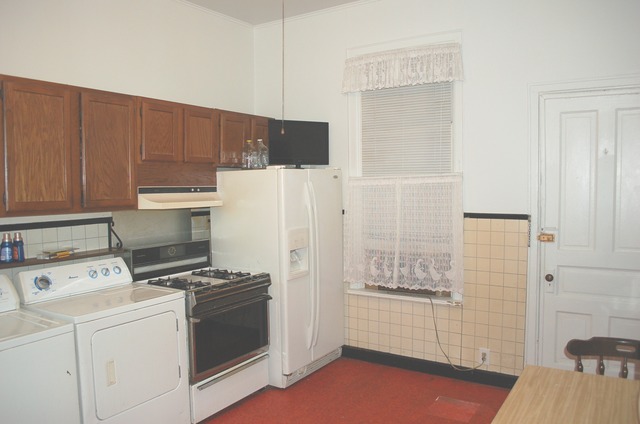 3414 North Seminary Avenue Chicago, IL 60657 - Photo 12 of 14 a kitchen with a refrigerator a stove and cabinets