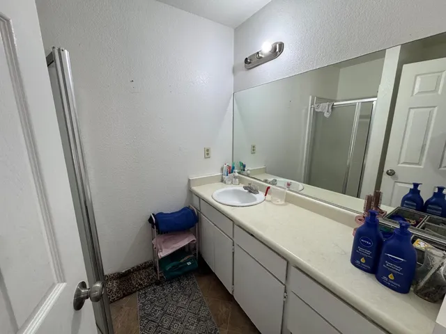 a bathroom with a double vanity sink and a mirror