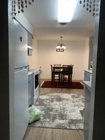 a view of kitchen with furniture and wooden floor