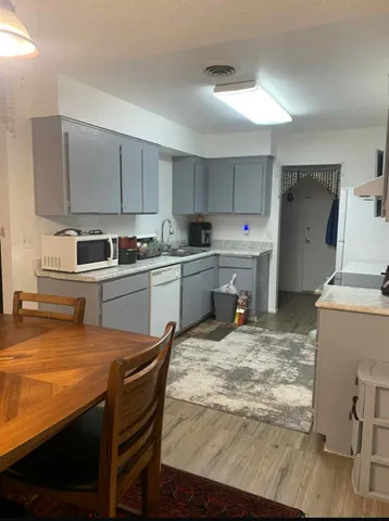 a kitchen with a sink a stove and cabinets