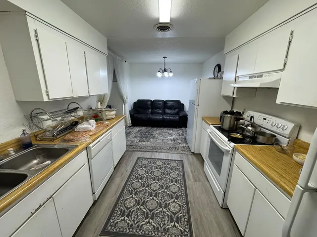 a kitchen with a sink stove and cabinets