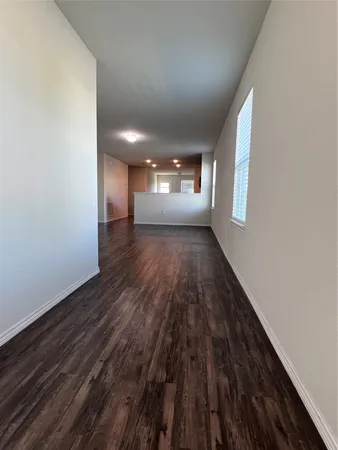a view of a room with wooden floor and window