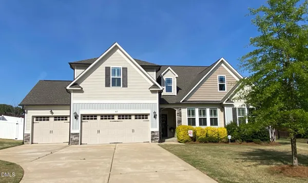 a kitchen with kitchen island granite countertop a counter space a sink appliances and cabinets