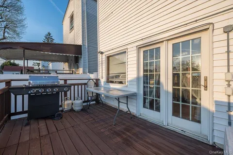 a view of roof deck with wooden floor and seating space