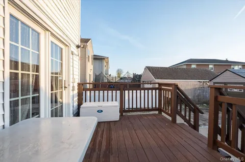 a view of a balcony with wooden floor and fence