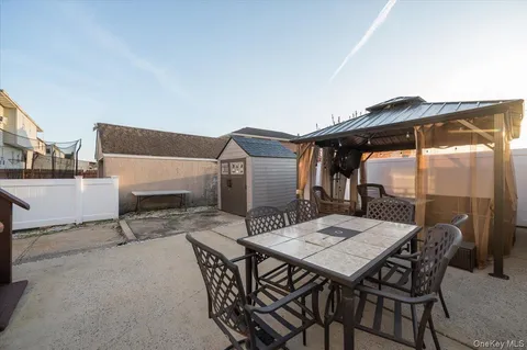 a view of a patio with a table and chairs