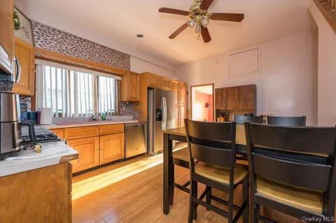 a kitchen with stainless steel appliances kitchen island granite countertop a stove a sink and a refrigerator