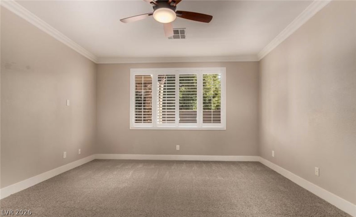 264 Pointe Ranier Avenue Henderson, NV 89012 - Photo 15 of 43 A well-lit bedroom offering a quiet retreat with plush carpeting and a modern ceiling fan.