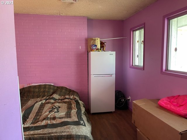 37811 Upper Camp Creek Road Springfield, OR 97478 - Photo 21 of 30 a bedroom with a bed and a refrigerator