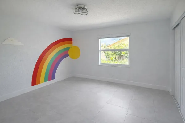 a view of a room with window and a ceiling fan
