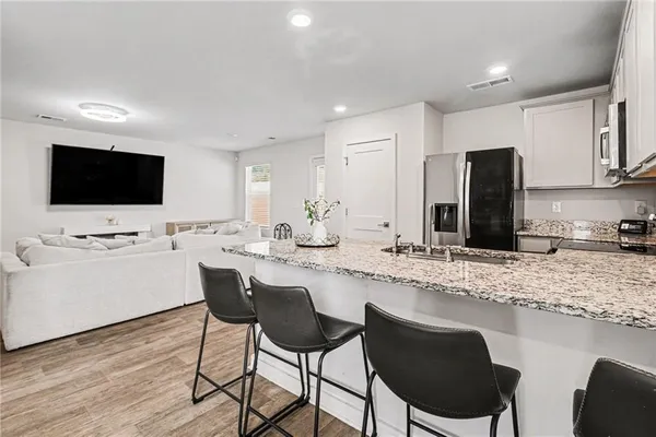 a kitchen with a sink cabinets and wooden floor